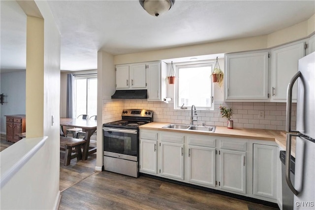 kitchen featuring stainless steel appliances, dark hardwood / wood-style flooring, white cabinetry, and sink