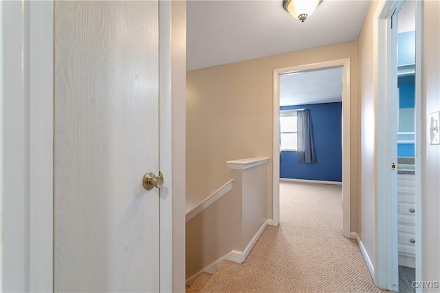 hallway with light colored carpet