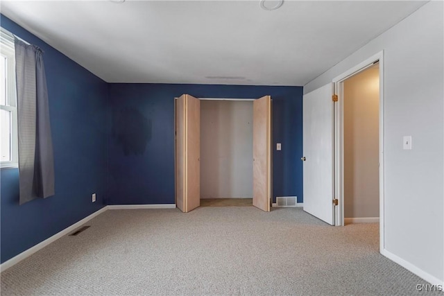 unfurnished bedroom with carpet flooring and multiple windows