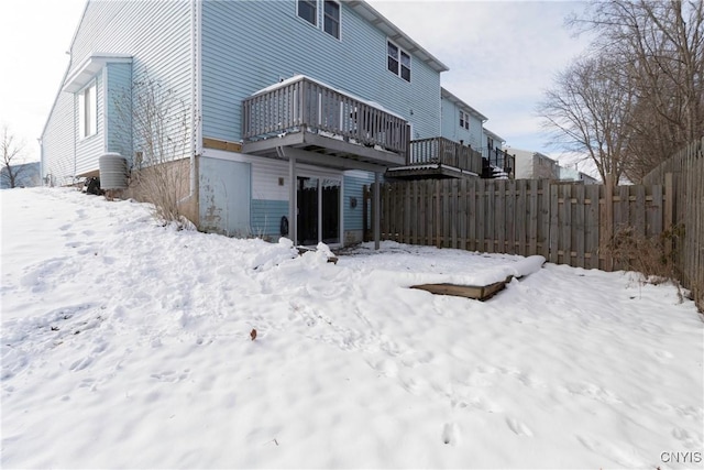 view of snow covered back of property