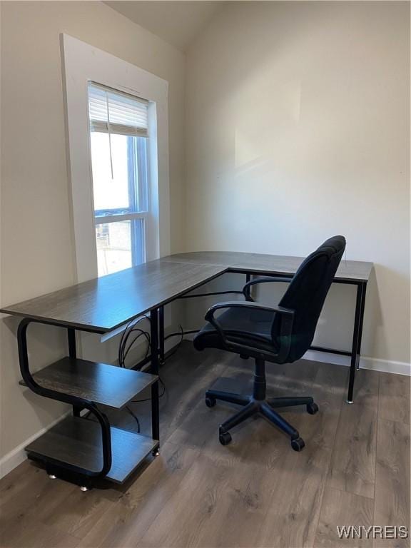 office space with vaulted ceiling and hardwood / wood-style flooring