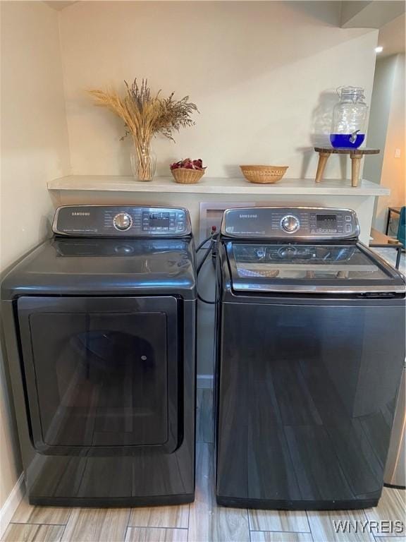 clothes washing area with washer and clothes dryer