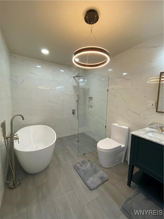 full bathroom with toilet, shower with separate bathtub, tile walls, and vanity