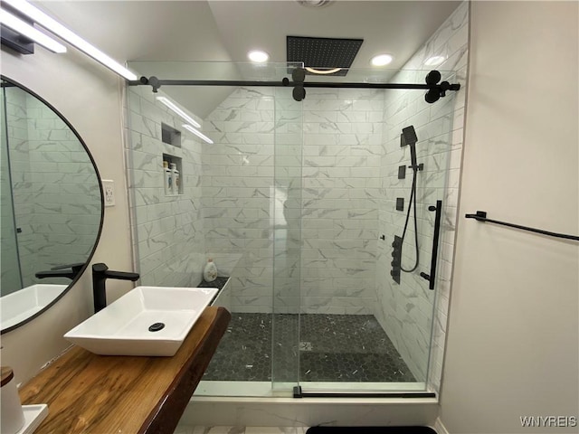 bathroom featuring sink and a shower with shower door