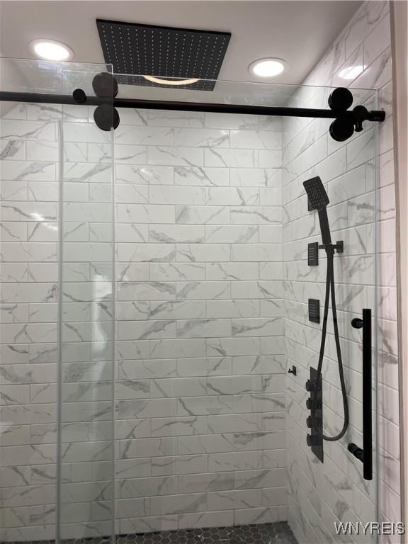 bathroom with a shower with door