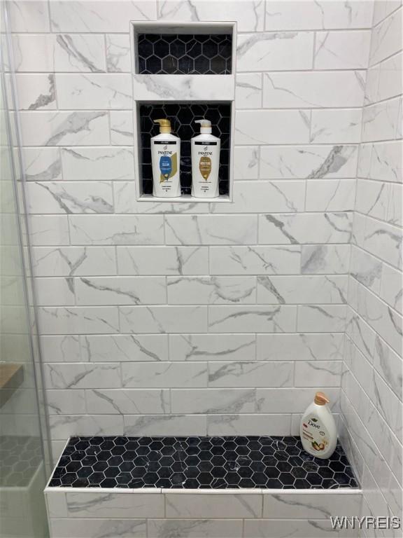 bathroom with a tile shower