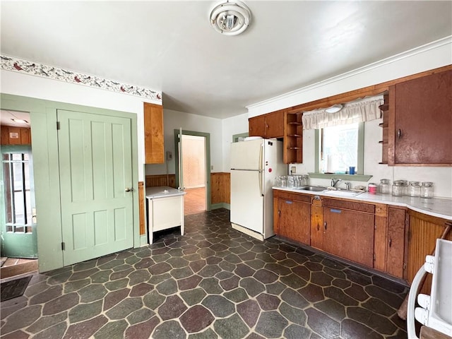 kitchen featuring sink, range, and white fridge