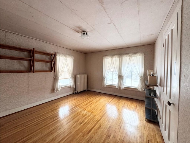 interior space with light hardwood / wood-style flooring and radiator