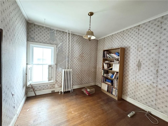 miscellaneous room with crown molding, hardwood / wood-style flooring, and radiator