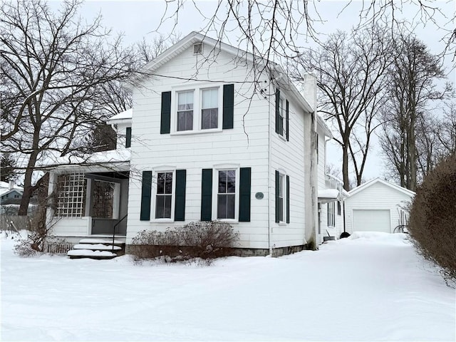 view of front of house with a garage and an outdoor structure