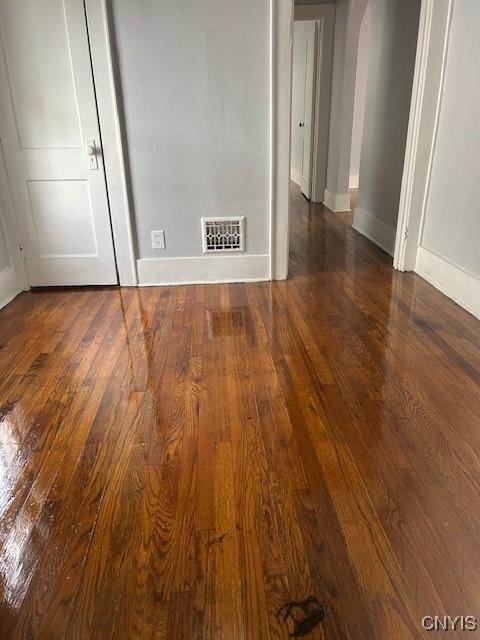 empty room featuring dark wood-type flooring