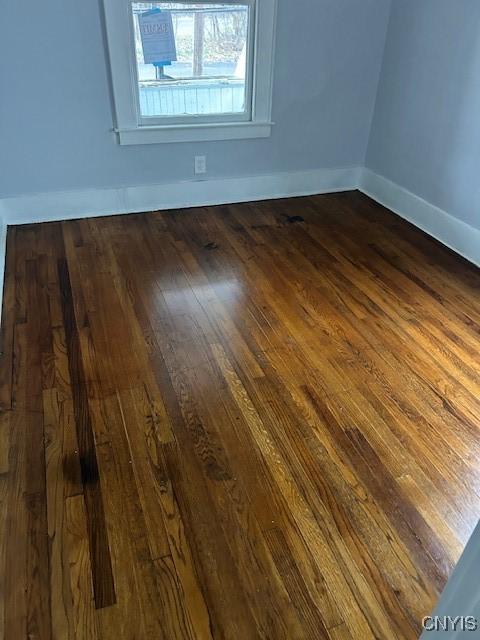 unfurnished room featuring dark hardwood / wood-style floors