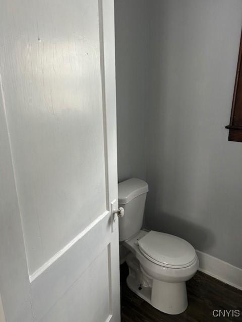 bathroom featuring hardwood / wood-style floors and toilet