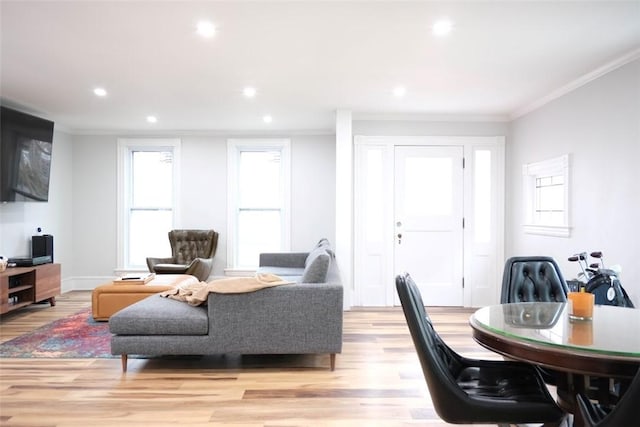 living room featuring light wood-type flooring and crown molding