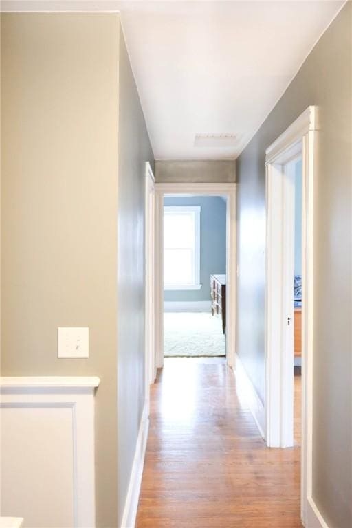 corridor with light wood-type flooring