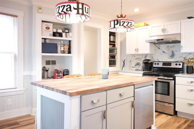 kitchen with butcher block counters, stainless steel range with electric cooktop, white cabinetry, a center island, and hanging light fixtures