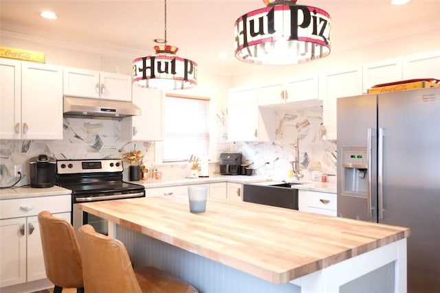 kitchen with wooden counters, appliances with stainless steel finishes, hanging light fixtures, a kitchen island, and white cabinets