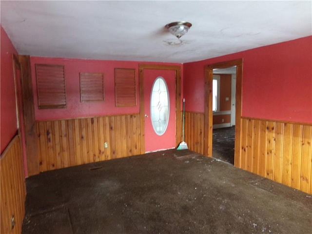 foyer with wood walls