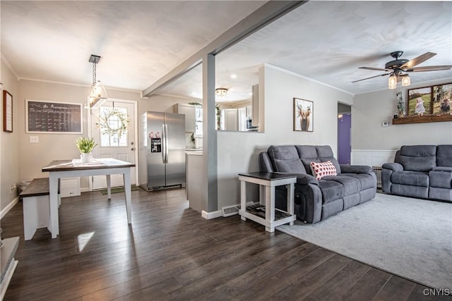 living room featuring ceiling fan, dark hardwood / wood-style flooring, and ornamental molding