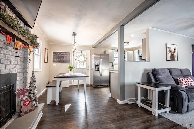 interior space featuring a fireplace, ornamental molding, and dark hardwood / wood-style floors