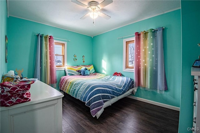 bedroom featuring dark hardwood / wood-style flooring, ceiling fan, and ornamental molding