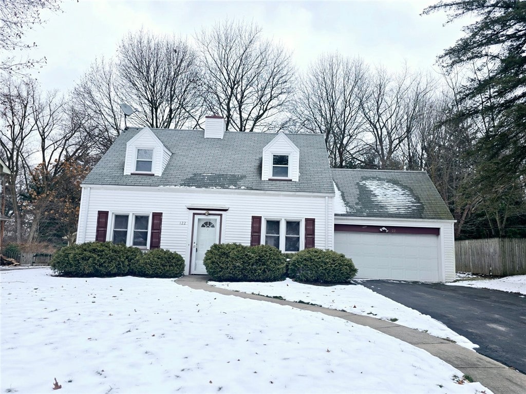 new england style home with a garage