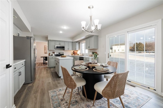 dining room with a notable chandelier, dark hardwood / wood-style floors, and sink