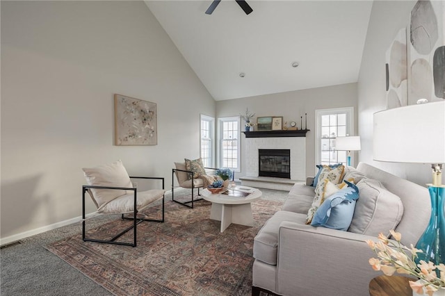 living room with ceiling fan, high vaulted ceiling, and carpet