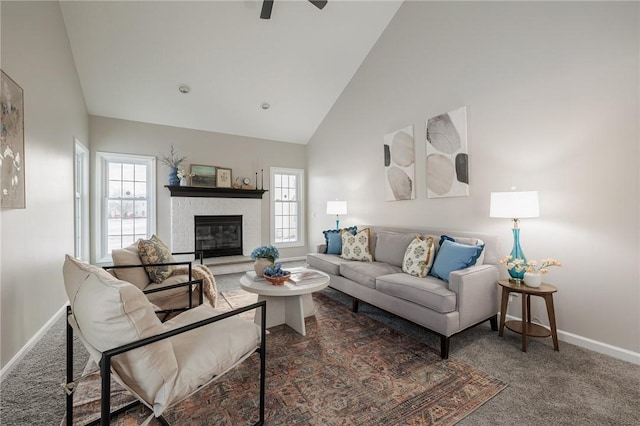 carpeted living room with ceiling fan, high vaulted ceiling, and a fireplace