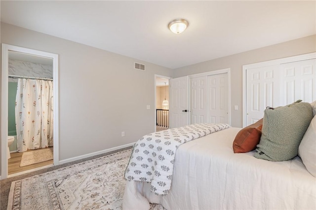 bedroom with ensuite bath and multiple closets