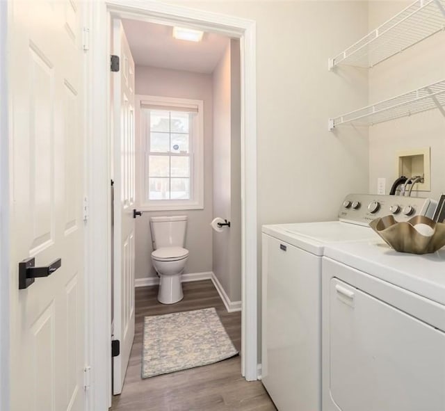 laundry room featuring light wood-type flooring and washer and clothes dryer