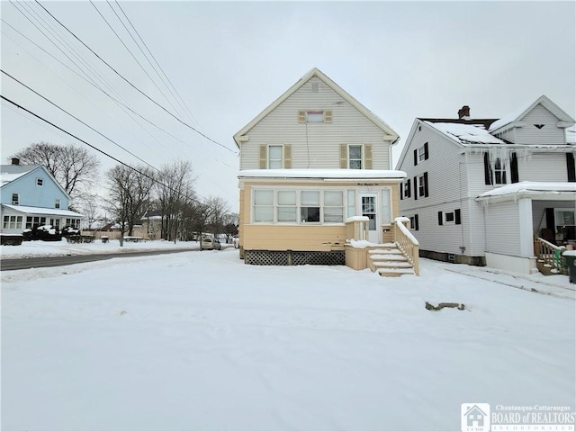 view of snow covered back of property