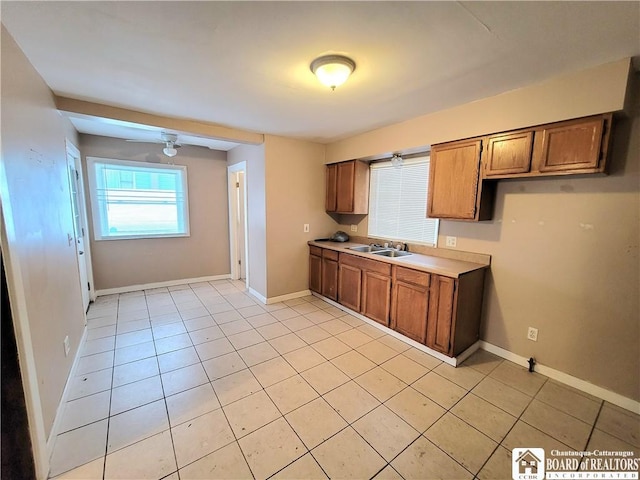 kitchen featuring sink, ceiling fan, and light tile patterned flooring