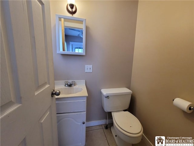 bathroom featuring toilet, tile patterned flooring, and vanity