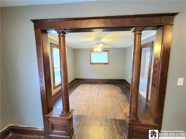 empty room with ceiling fan, ornamental molding, decorative columns, and hardwood / wood-style flooring