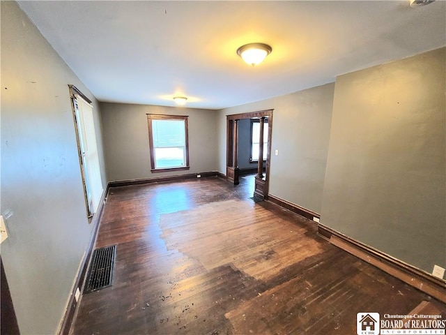 unfurnished room featuring dark hardwood / wood-style floors