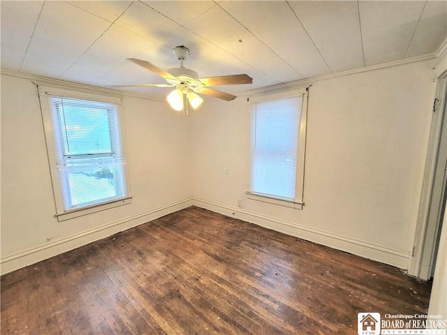 empty room with ceiling fan and dark hardwood / wood-style flooring