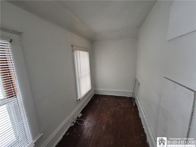 spare room with dark wood-type flooring