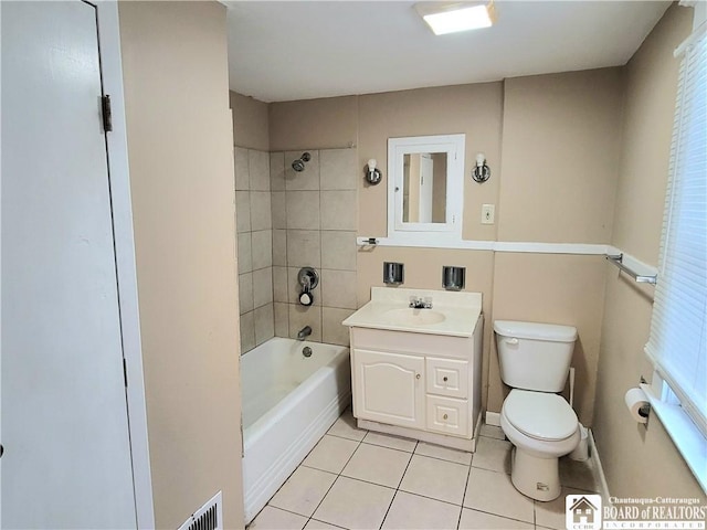 full bathroom with toilet, vanity, tile patterned floors, and tiled shower / bath combo