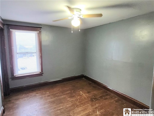 empty room with dark wood-type flooring and ceiling fan