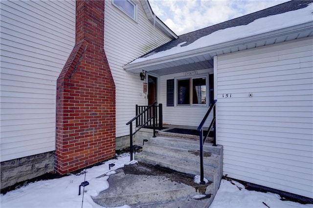 view of snow covered property entrance