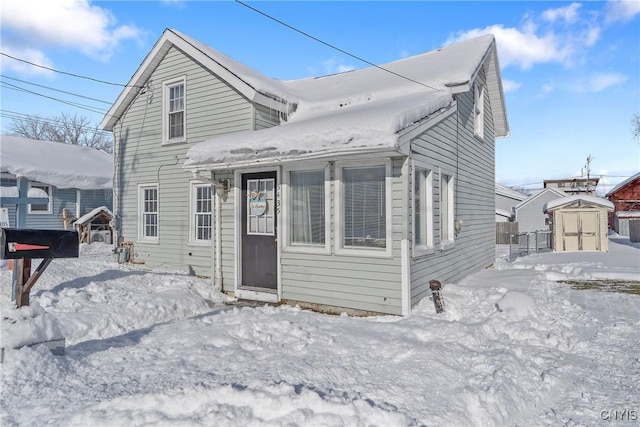 view of front of property with a shed