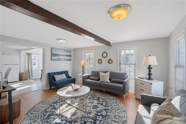 living room with beam ceiling and light hardwood / wood-style floors