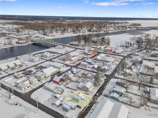 snowy aerial view featuring a water view