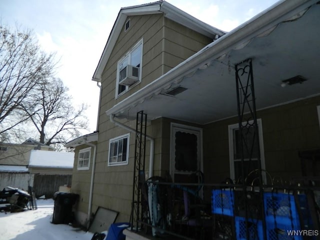 snow covered property with cooling unit