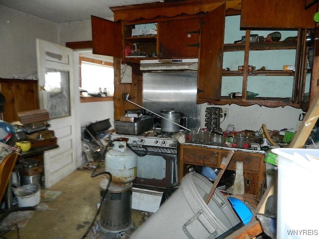 kitchen featuring concrete floors and white gas range