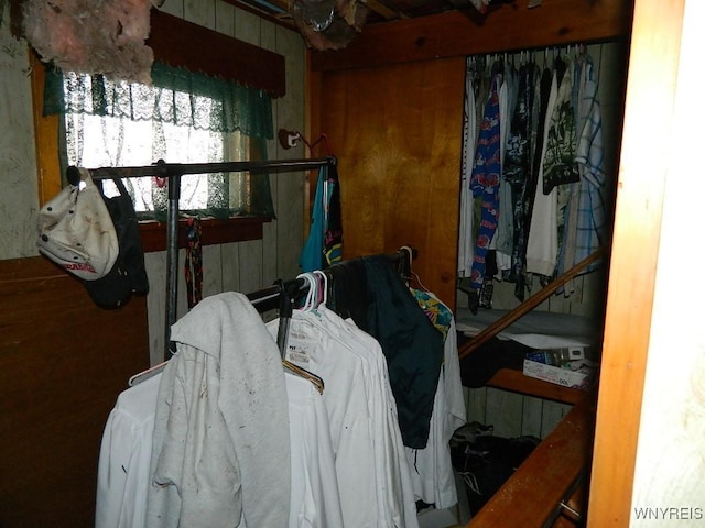 bedroom featuring a closet and wood walls