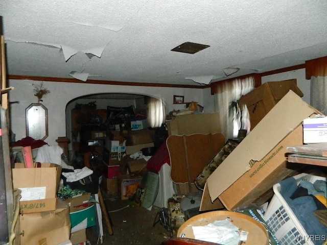 miscellaneous room with a textured ceiling and crown molding