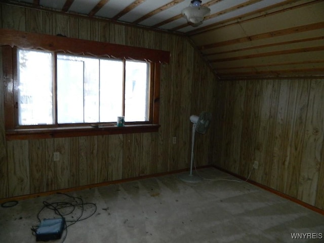 unfurnished room featuring vaulted ceiling