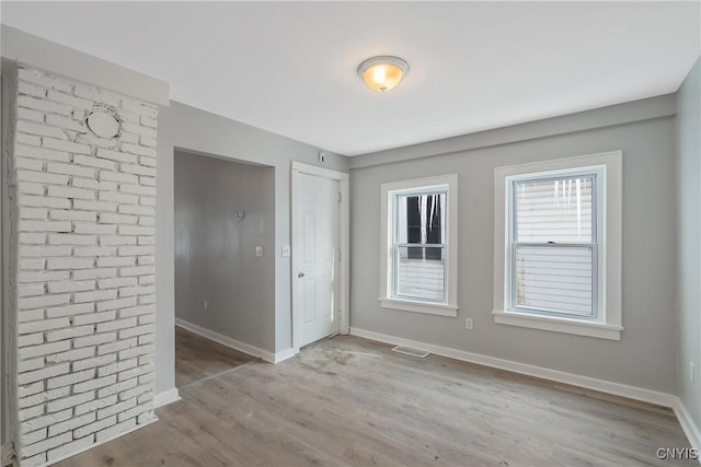 empty room with light hardwood / wood-style floors